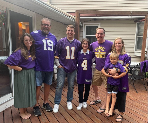 Klaus standing with friends and family on a backyard deck