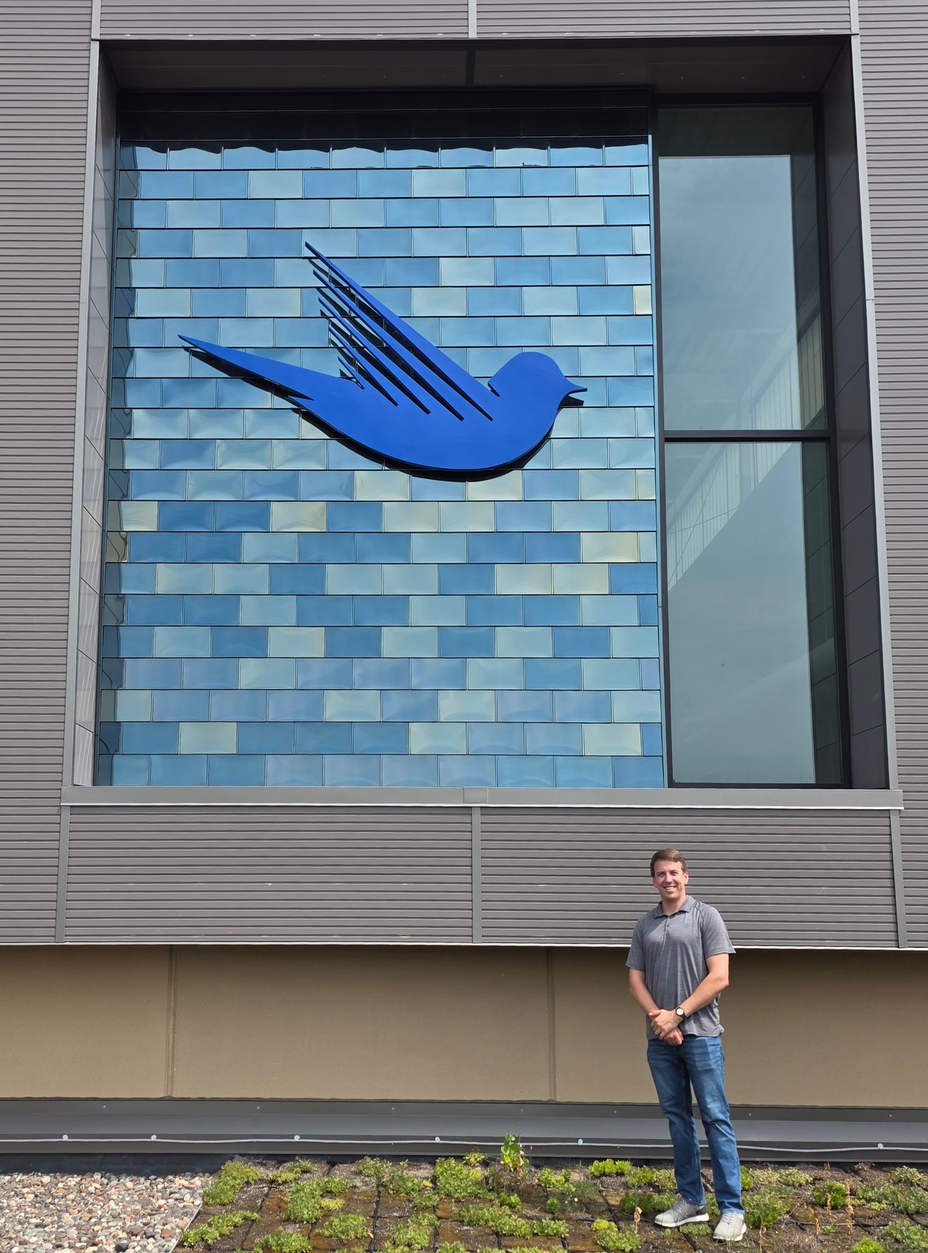 Klaus outside the Robbinsdale water treatment facility near the blue bird mural
